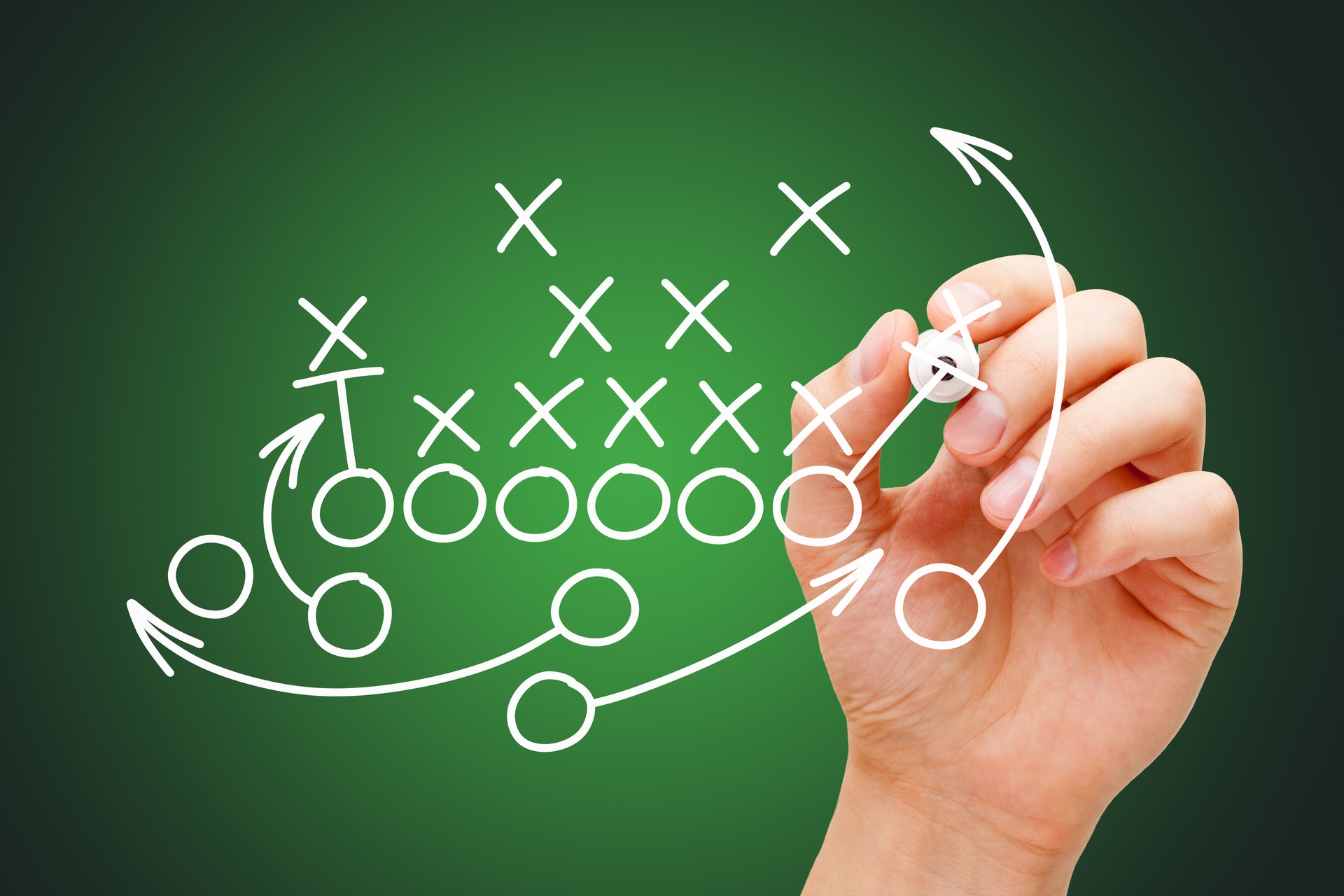 Coach Drawing American Football Game Playbook In Locker Room